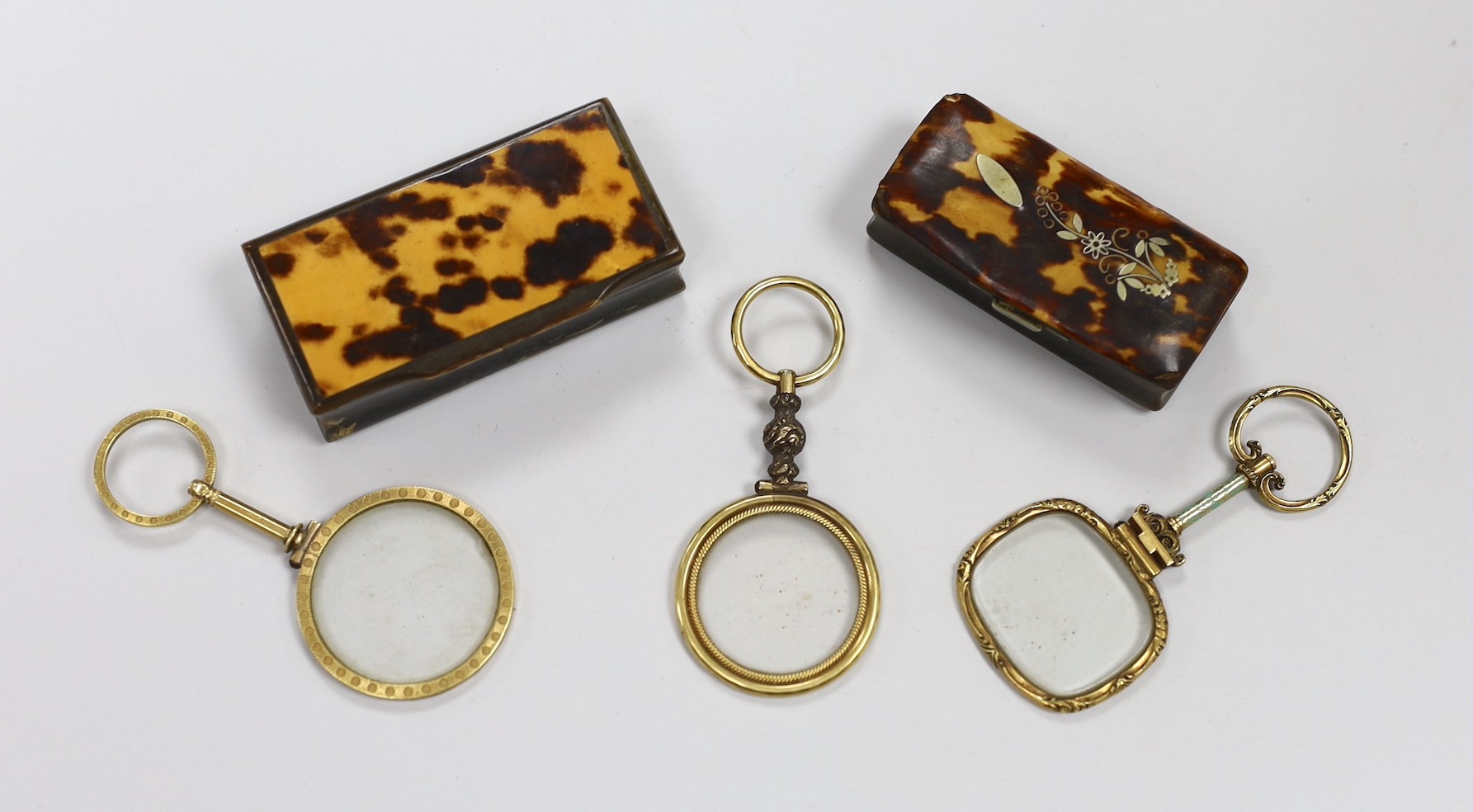 Two 19th century tortoiseshell and horn snuff boxes and three decorative gilt metal monocles